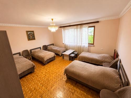 a room with three beds and a window at Adams Rest House in Yeghegnadzor