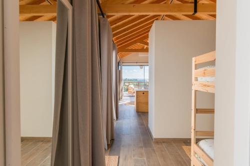 a room with curtains and a hallway with bunk beds at Eira das Maçãs - Óbidos 