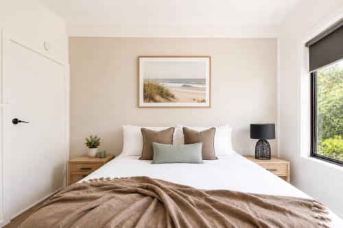 a bedroom with a bed and a window at Prom Coast Apartments in Sandy Point