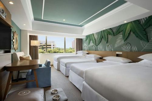 a row of beds in a hotel room at Sheraton Grande Tokyo Bay Hotel in Urayasu