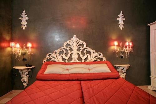 a red and white bed in a room with lights at Hotel Columbia Wellness & Spa in Montecatini Terme