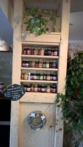 a refrigerator with jars of food in it at Altstadt Pension Orchidee in Wernigerode