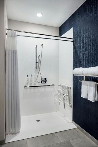 a bathroom with a shower with a glass door at Fairfield by Marriott Inn & Suites Mattoon in Mattoon
