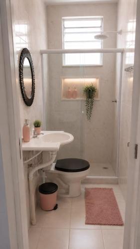 a bathroom with a shower and a sink and a toilet at Copacabana Rooms & Hostel in Rio de Janeiro