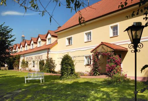 a building with a bench in front of it at penzion Dvorce in Třeboň