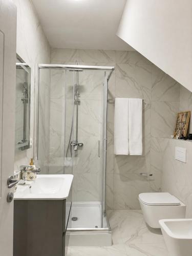 a bathroom with a shower and a sink and a toilet at Green Hill Villa in Tirana