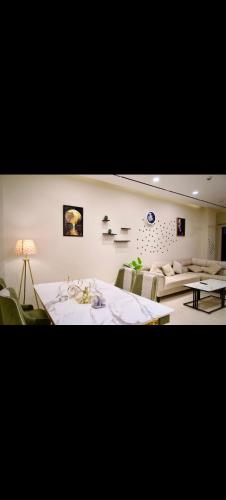 a living room with a table and a couch at White420 apartment in Rawalpindi