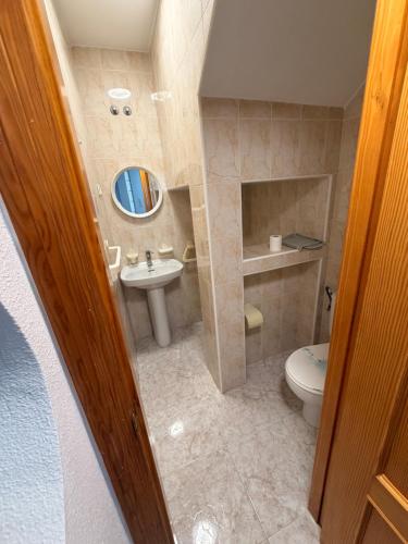 a small bathroom with a sink and a toilet at Villa Bella in Los Altos