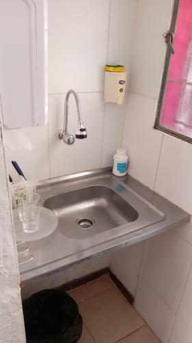 a sink in a small room with at Brisas Del Rio Apart Hotel in Termas del Daymán