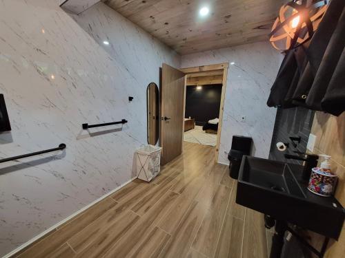 a bathroom with a sink and a counter and a door at Seigneurie de Valdombre in Lévis