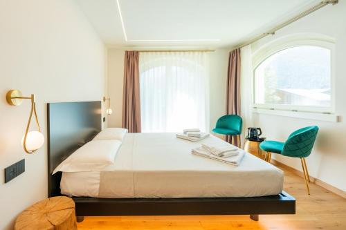 a hotel room with a bed and a window at Hotel Villa Amabile in Villa dʼAllegno