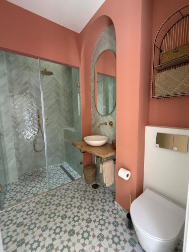 a bathroom with a shower and a toilet and a sink at AL do Barão - Casa de Charme com Piscina Privada in Vila Real de Santo António