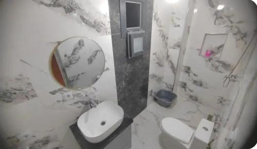 a bathroom with a toilet and a sink and a mirror at Villa zahra 7 in Kêf Bisnês
