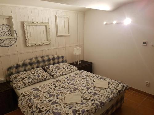a bedroom with a bed with two towels on it at Pension Konírna in Huntířov