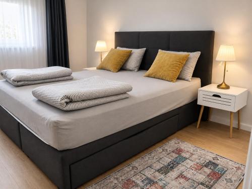 a bedroom with a large bed with two pillows at Apartman PEPI LUXURY in Novi Zagreb