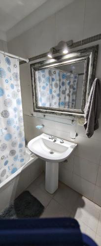 a bathroom with a white sink and a mirror at Recovas III in Pilar