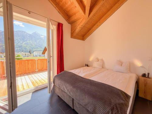 a bedroom with a bed and a large window at Kipaji 3 in Kötschach