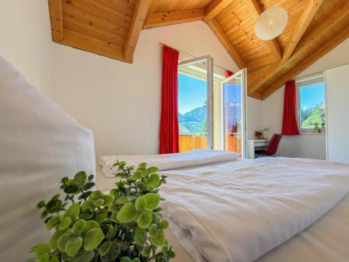 a bedroom with a bed and a potted plant at Kipaji 2 in Kötschach
