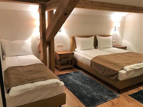 two beds in a small room with at Haus Planegg XL in Rangersdorf