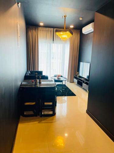 a kitchen with a sink and a living room at Colombo Trizen Nuva Apartments in Colombo
