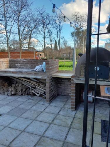 a picnic table and a grill on a patio at Quinta Doña Delia in Agote