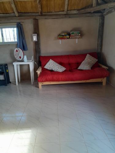a red couch sitting in a living room at Quinta Doña Delia in Agote
