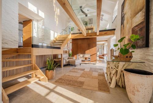 a large room with a staircase and a living room at Treloggas Retreat in Truro
