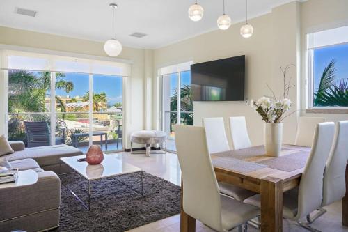 a living room with a dining room table and a couch at LUXURIOUS APARTMENT IN LEVENT FRONT EAGLE BEACH in Palm-Eagle Beach