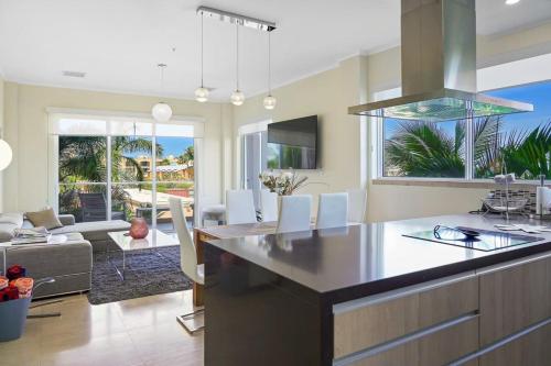 a kitchen and living room with a large island in the middle at LUXURIOUS APARTMENT IN LEVENT FRONT EAGLE BEACH in Palm-Eagle Beach