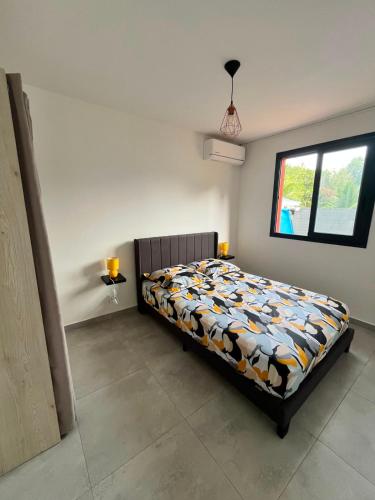 a bedroom with a bed in a room with a window at Villa Aloa Private pool in Les Abymes