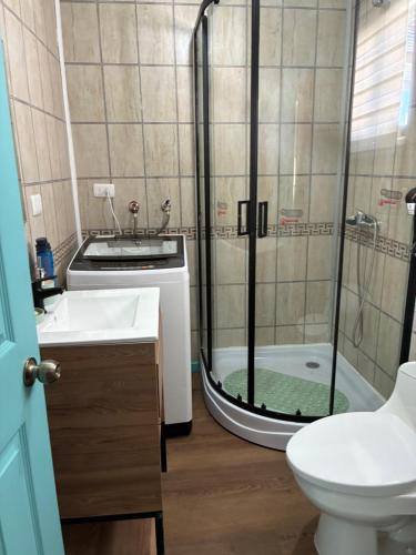 a bathroom with a shower and a toilet and a sink at cabañas notuco in Natuco