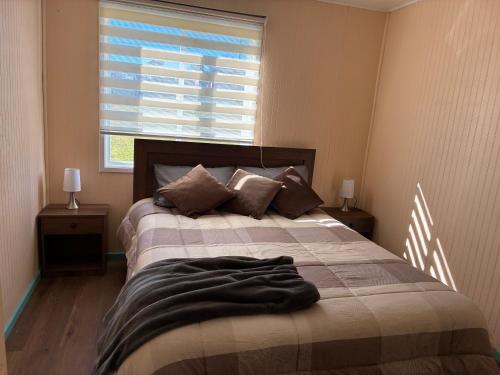 a bedroom with a bed with a blanket on it at cabañas notuco in Natuco