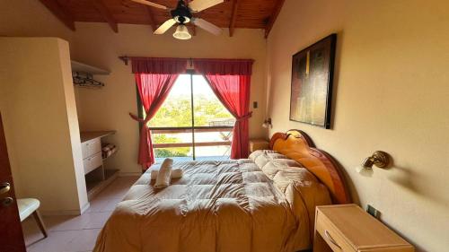 a bedroom with a bed in front of a window at Agua Dorada Apart in Cavalango