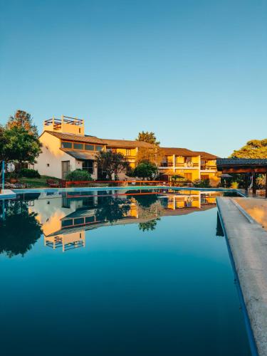 a pool of water in front of a building at Agua Dorada Apart in Cavalango
