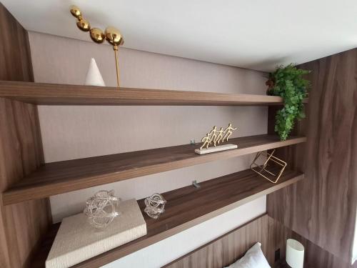 a room with wooden shelves on the wall at SKY design Alphaville by Rhouses in Barueri
