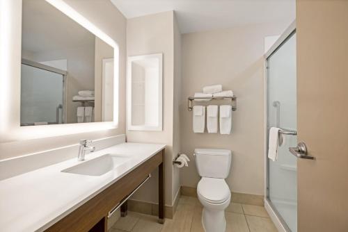 a bathroom with a sink and a toilet and a mirror at Holiday Inn Express Rolla by IHG in Rolla