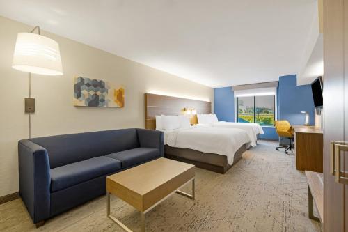a hotel room with a bed and a couch at Holiday Inn Express Rolla by IHG in Rolla