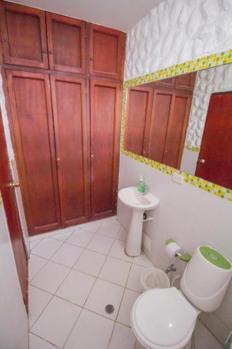 a bathroom with a toilet and a sink at Hostal Casa Lulú Santa Marta in Santa Marta