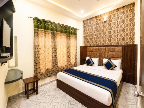 a hotel room with a bed and a television at Hotel Urban Stay - Mathura in Mathura