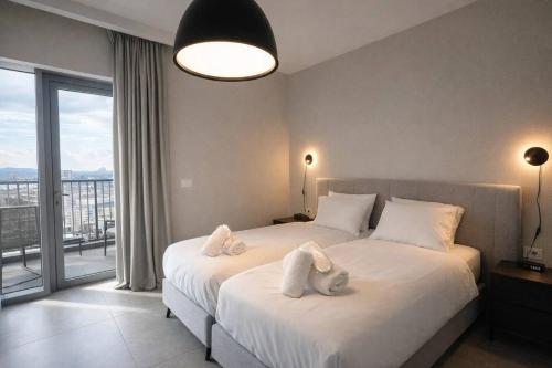 a bedroom with a large bed with white pillows at 2 Br Apartment In Savyoney Tower W Room in Jerusalem