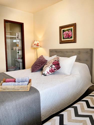 a bedroom with a bed with pillows on it at Casa à Beira Mar em Praia Seca Araruama RJ in Araruama