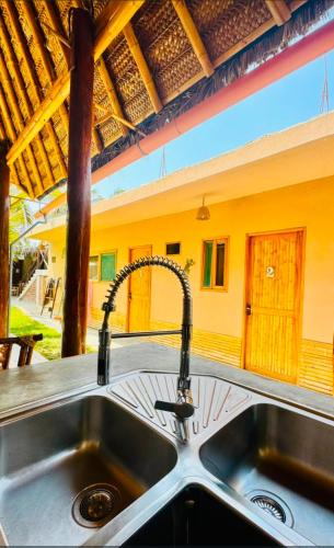 a sink in a kitchen with aaucet at IGUANA HOUSE in Máncora