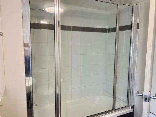 a shower with a glass door in a bathroom at Tranquil 3 Bedroom Retreat in Townsville City in Townsville