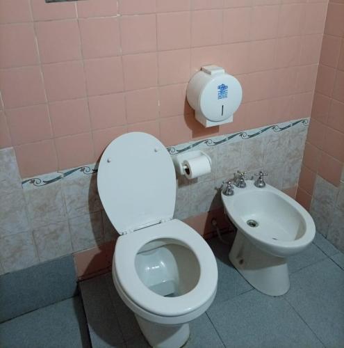 a bathroom with a toilet and a sink at Hostal Mechita Mamani in Cafayate