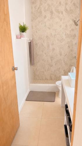 a bathroom with a shower and a toilet and a sink at Old Harbour Oasis in Old Harbour