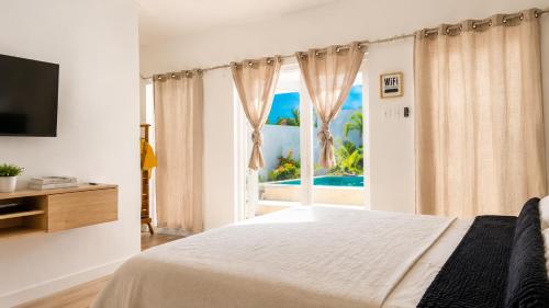 a bedroom with a bed and a view of the ocean at Old Harbour Oasis in Old Harbour