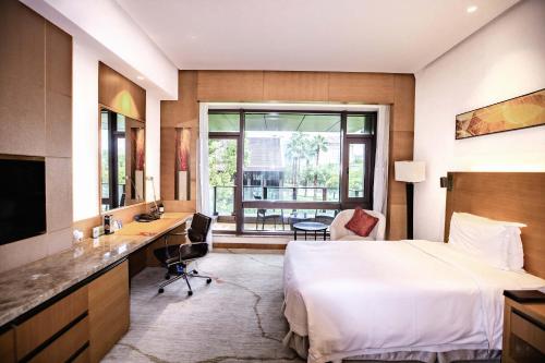a hotel room with a bed and a desk at DoubleTree By Hilton Jiaxing in Jiaxing