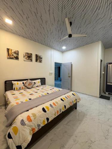 a bedroom with a bed and a ceiling fan at Countryside Retreat in Pune