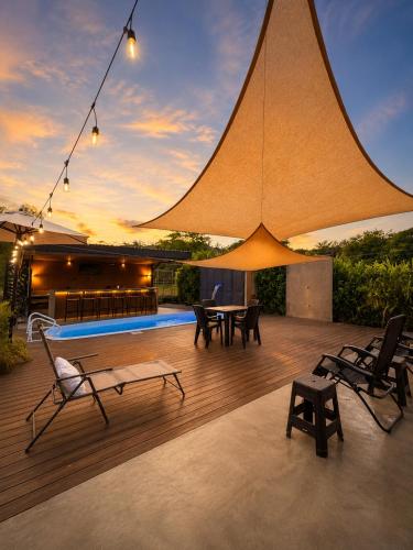 a patio with chairs and a table and a pool at Villa Horizonte in Plazuela