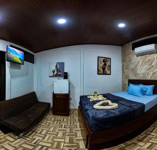 a bedroom with a large bed and a couch at Tortuguero7 lake view in Tortuguero